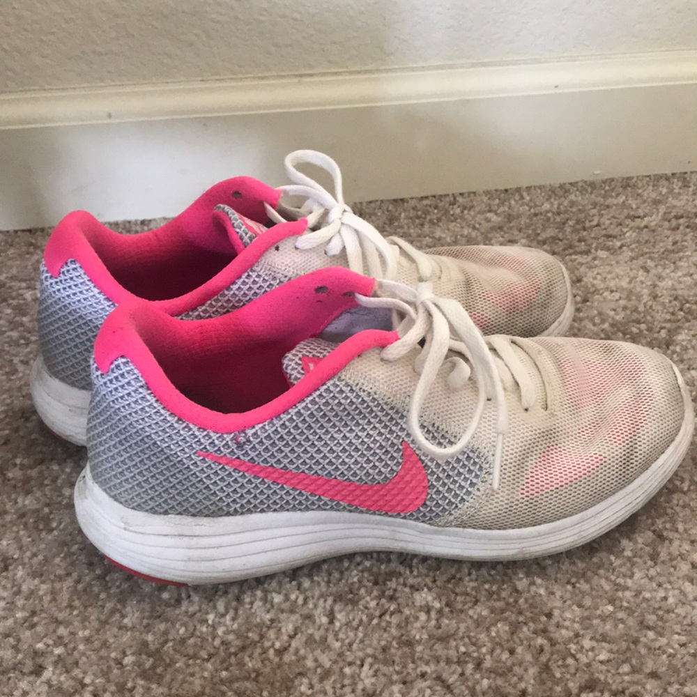 Pink and white Nike shoes